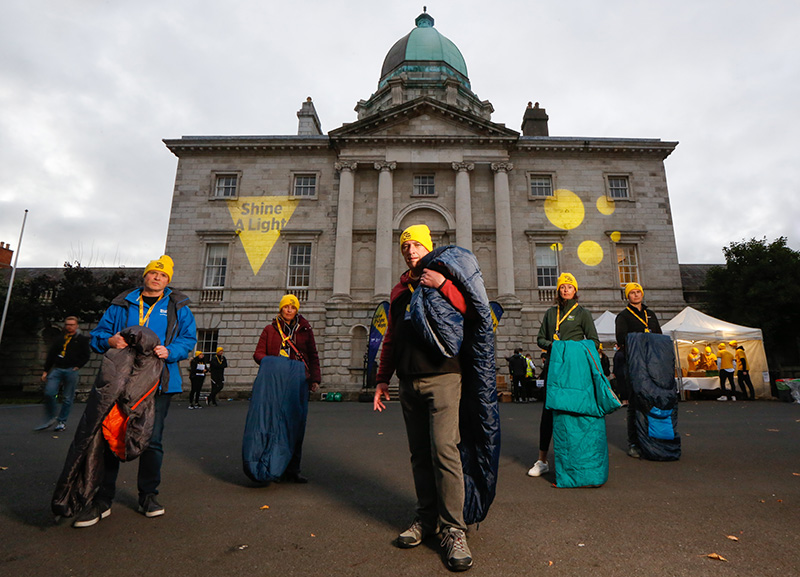 A group of people holding sleeping bags to raise awareness for Shine A Light